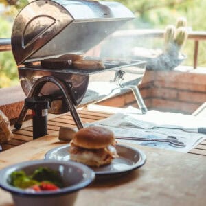A smoky BBQ cooking burgers.