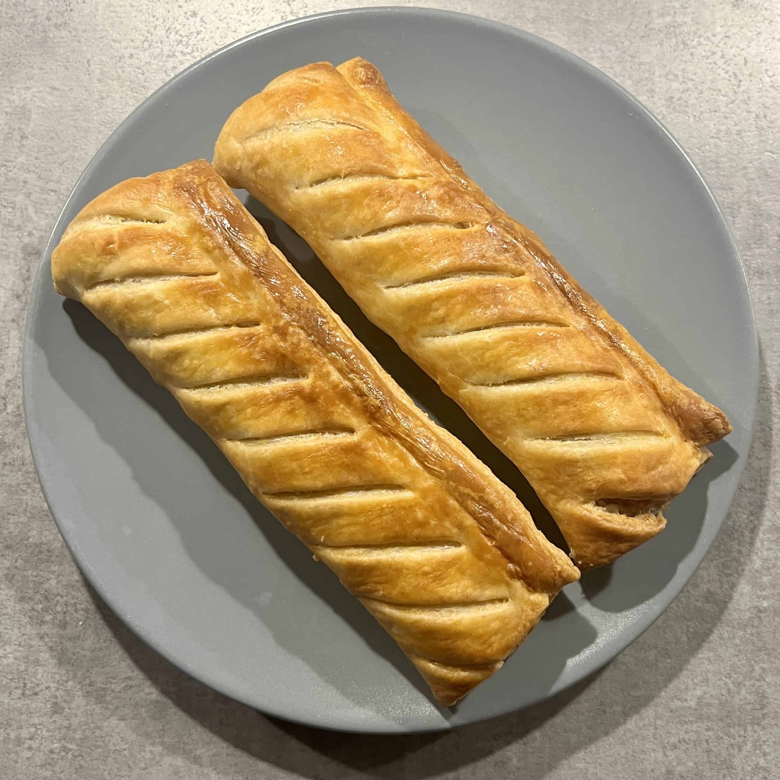 Two Greggs Sausage Rolls on a plate.