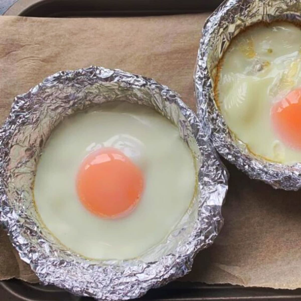 Two eggs in foil which have been baked in the oven.