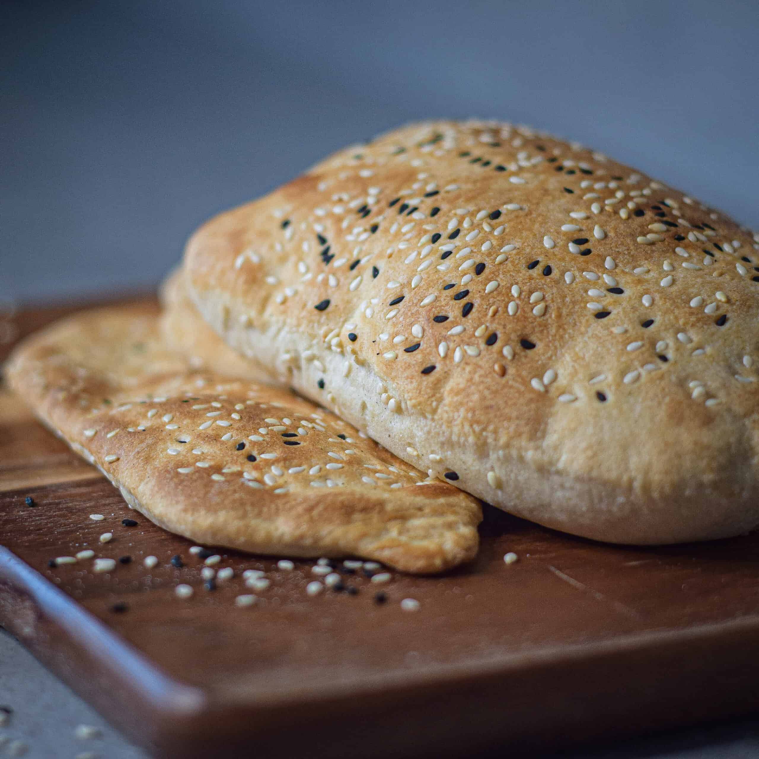 Shaobing Chinese flatbread on a chopping board.
