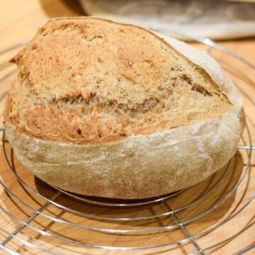 Sourdough bread on a cooling rack.