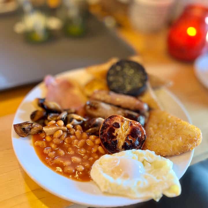 A full English breakfast with bacon, beans and poached egg.