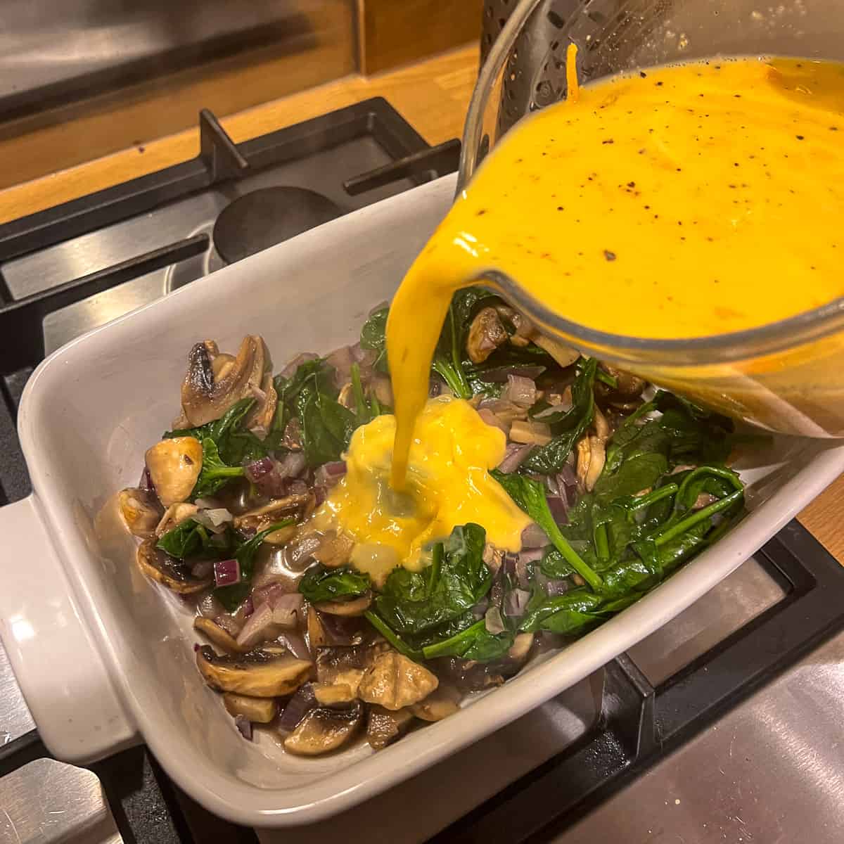 mushroom and spinach frittata pour mix onto frittata