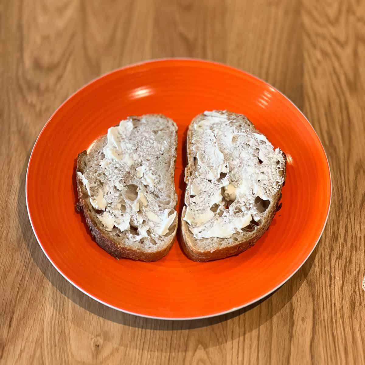 Two slices of sourdough bread buttered.