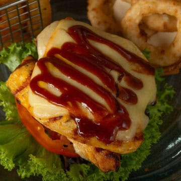 Hunters chicken with cheese and bbq sauce on a salad.