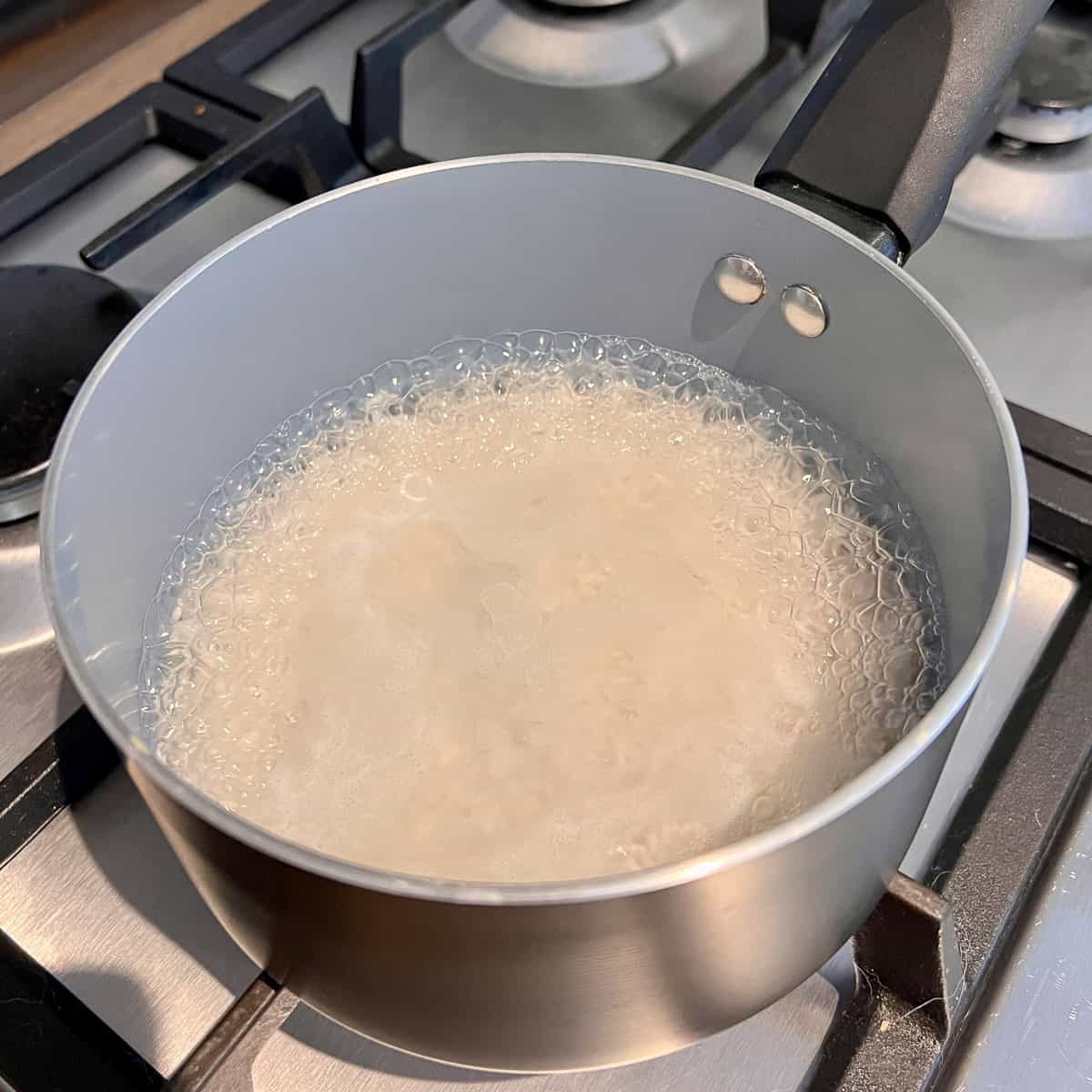 Rice in a pan boiling off water.