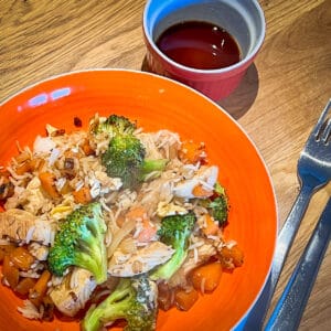 Egg fried rice with chicken, broccoli, carrots, onion and garlic and soy sauce.