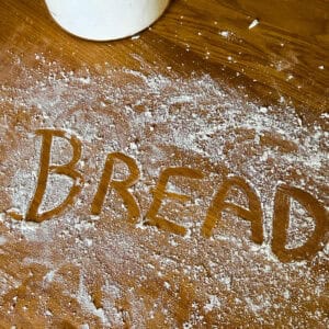 The word Bread written in flour.
