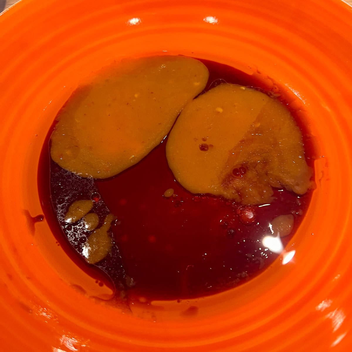 Sesame oil, soy sauce and lemon juice in a bowl.