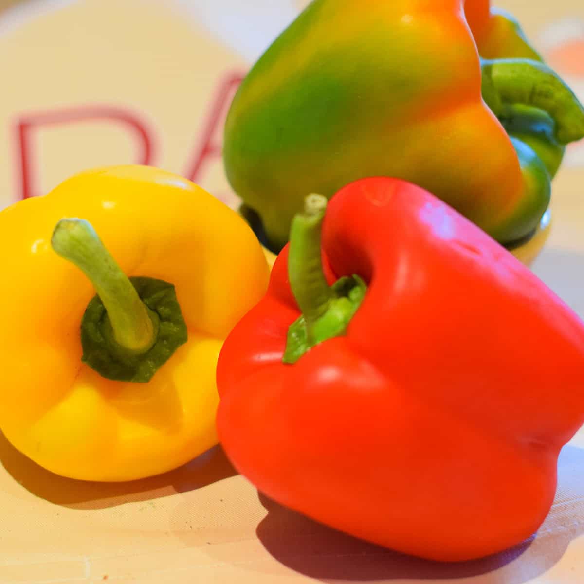 A red, yellow and green bell pepper.