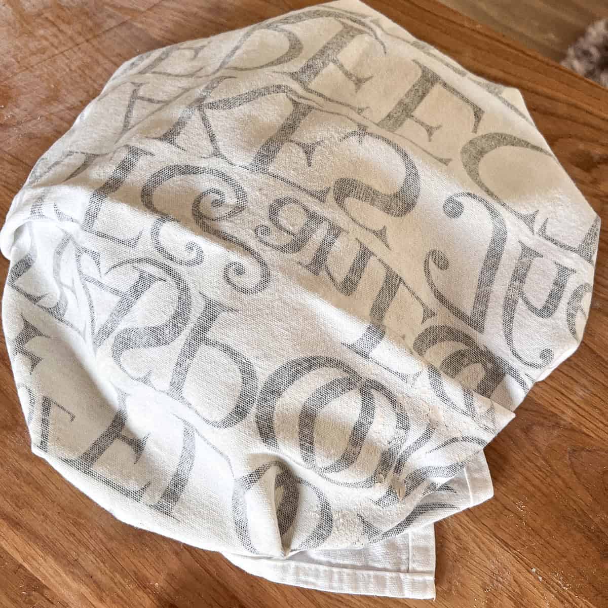 Pitta covered in a tea towel to steam further.