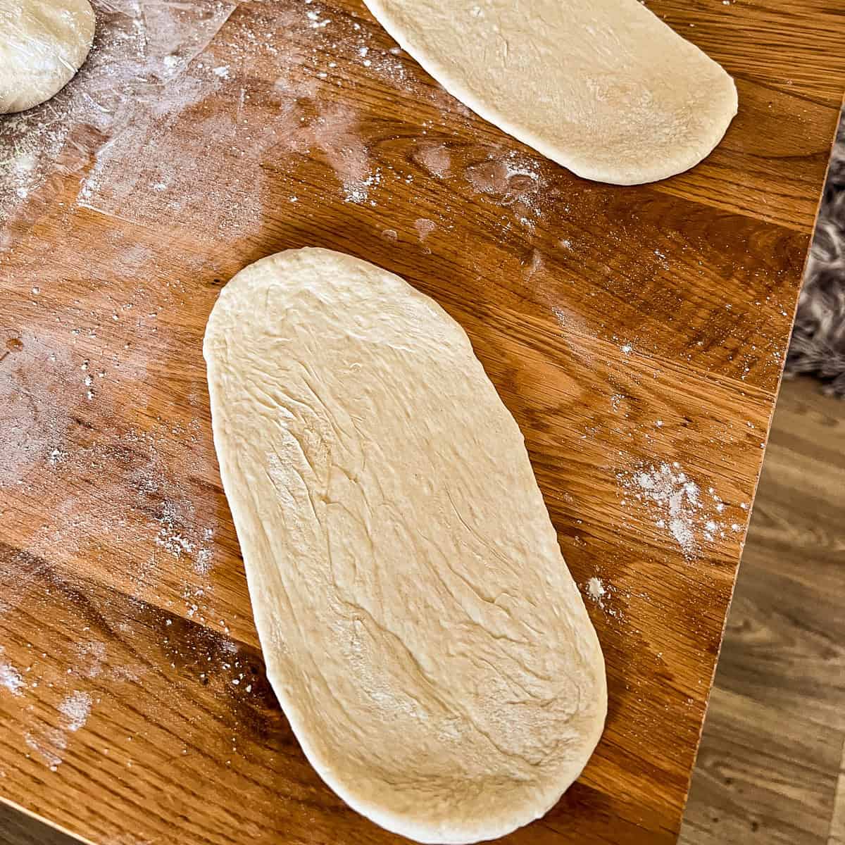 Flat pitta breads rolled out ready for baking.