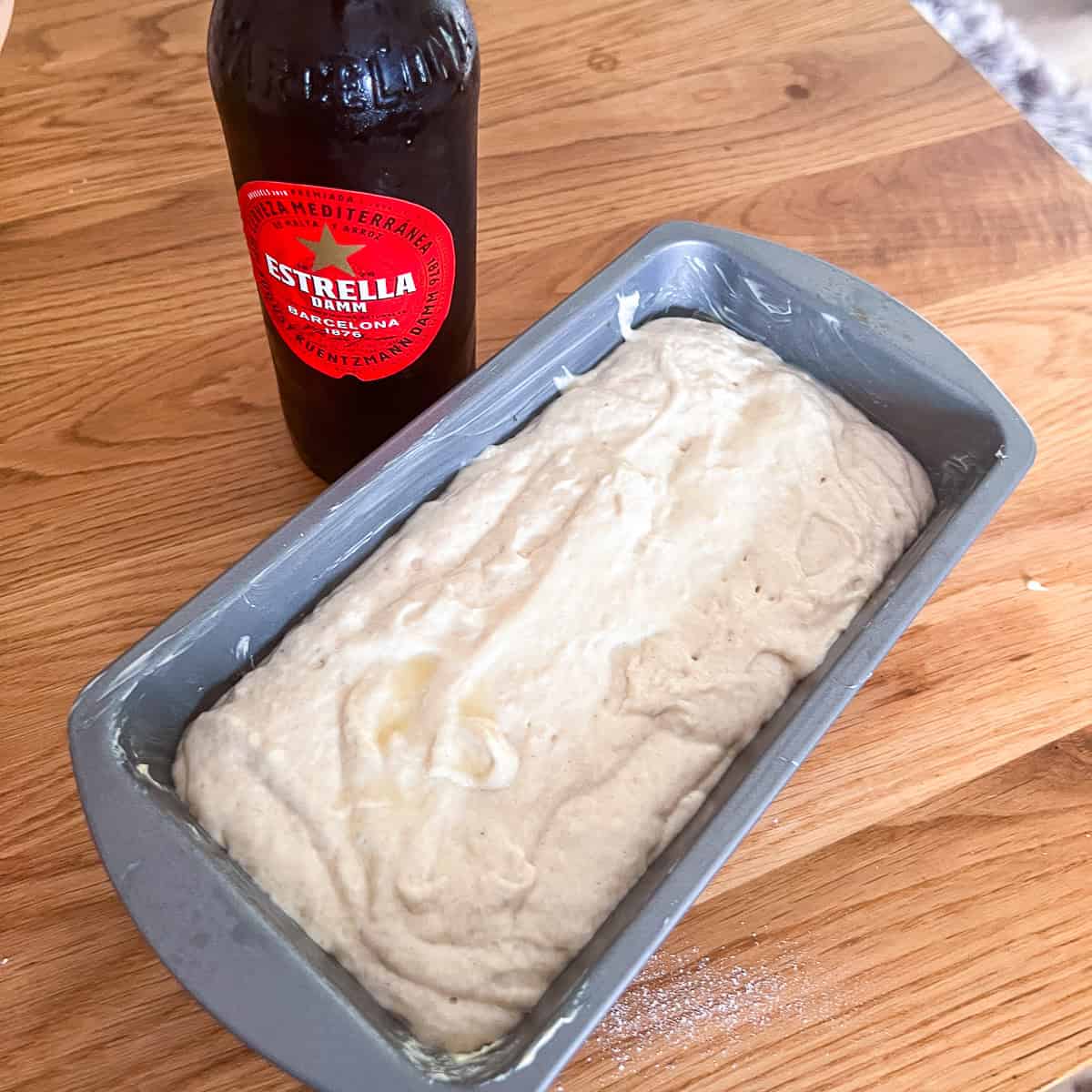 Estrella beer bread mixed in tin ready to cook.