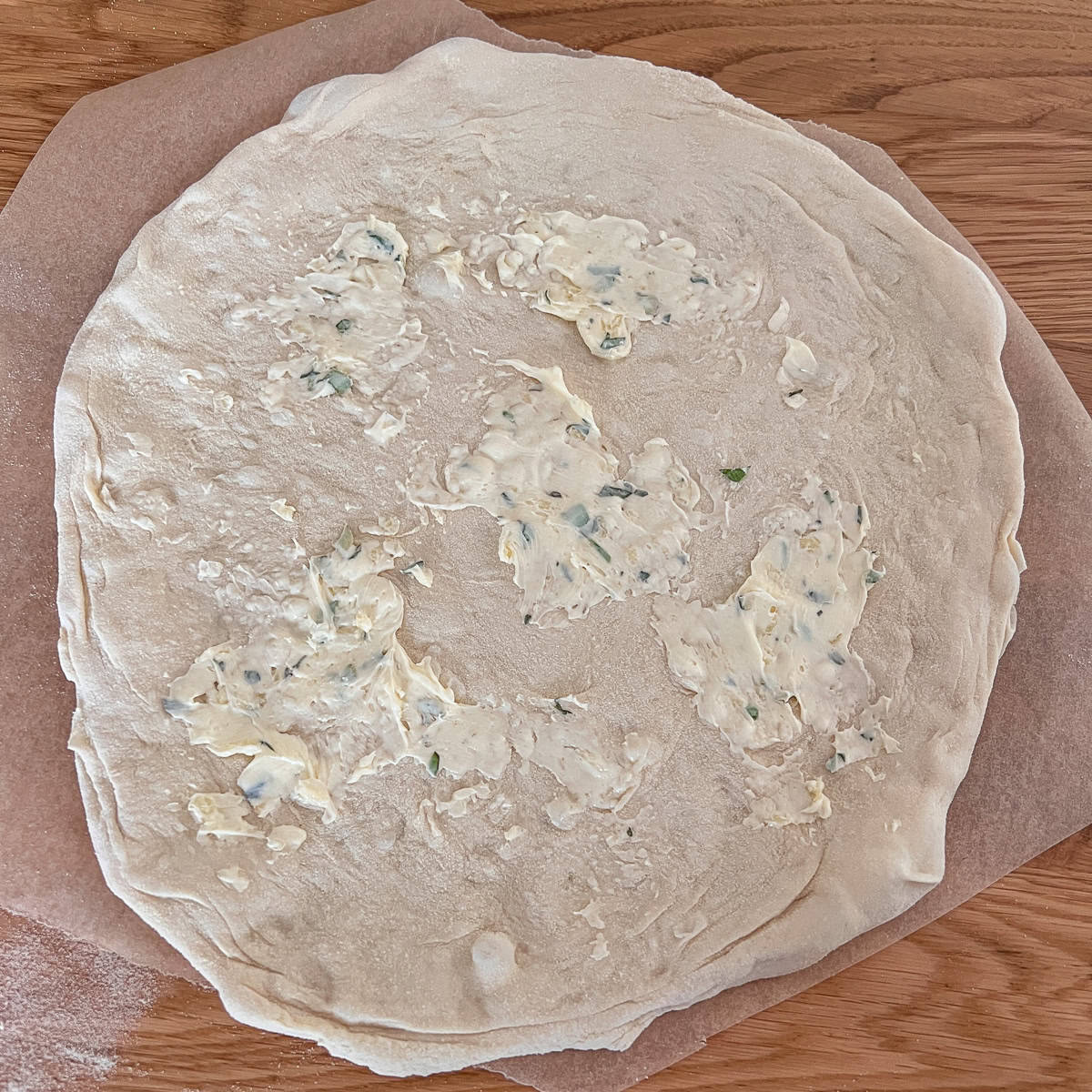 Garlic pizza bread with butter spread before cooking.