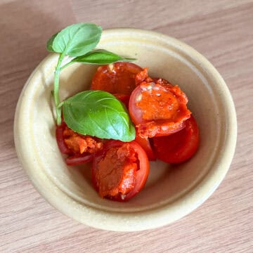 Nduja stuffed tomatoes with basil.