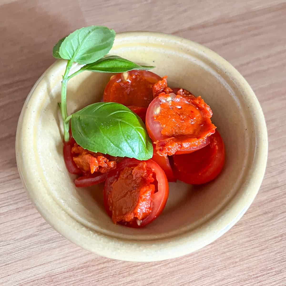 Nduja stuffed tomatoes with basil.