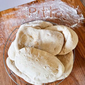 Pitta bread on a cooling rack.
