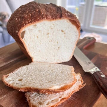 Sliced white bread on a chopping board.
