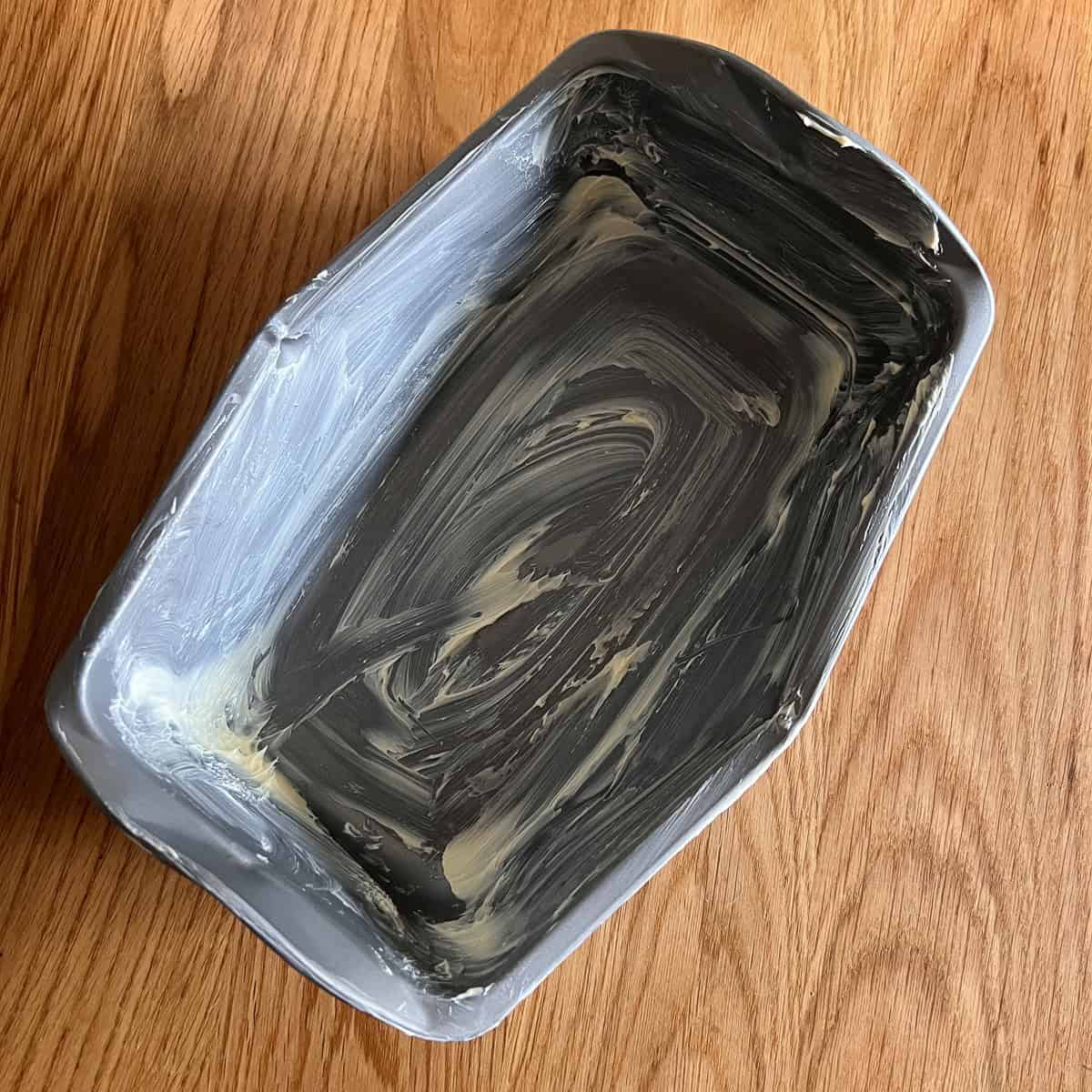 Greased up bread tin ready for shaped loaf.