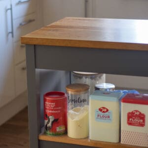 Tins of flour on a shelf.