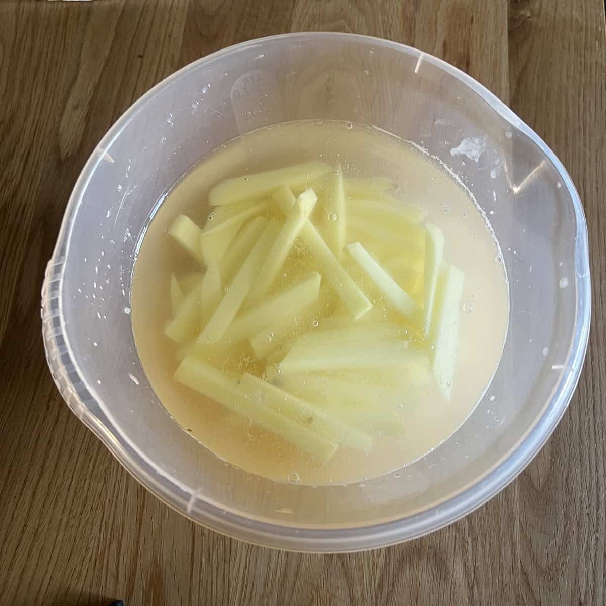 Chips soaking in salt water to get rid of starch.