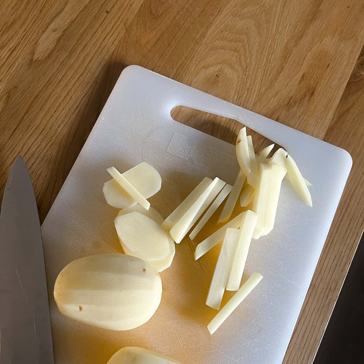 Slicing potatoes into fries.