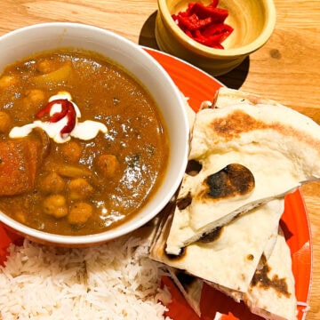 Naan bread with side of rice and a chana bhuna curry.