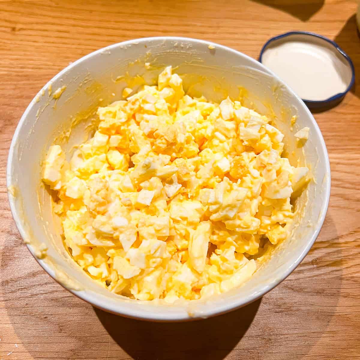 Egg mayo and mustard mixed in a bowl.