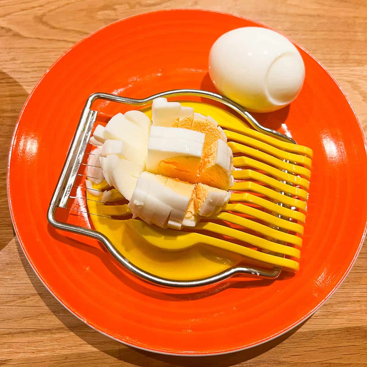 Hard boiled egg being sliced.