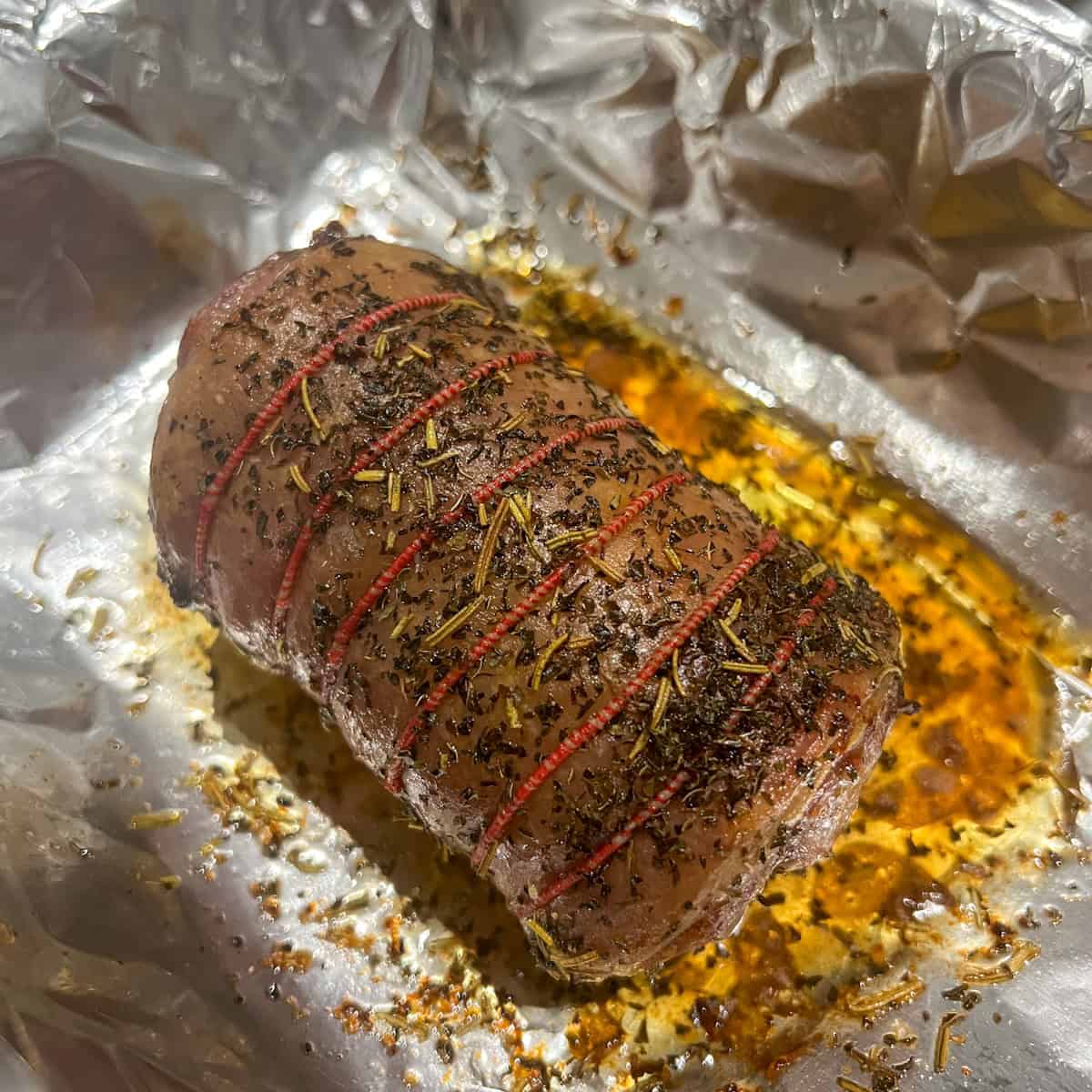 Roast lamb cooked in a roasting tin.