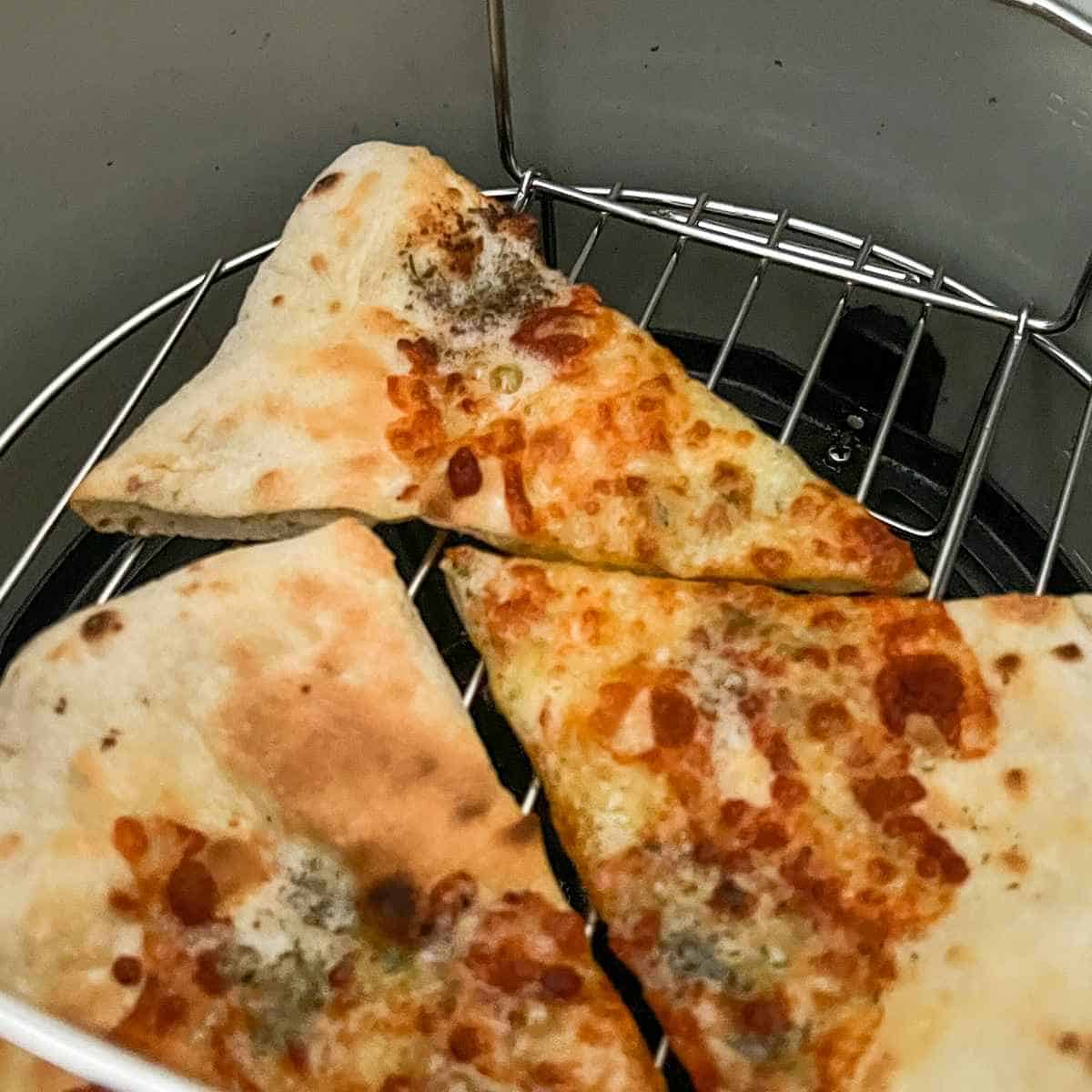 Image of Reheating leftover pizza in air fryer.