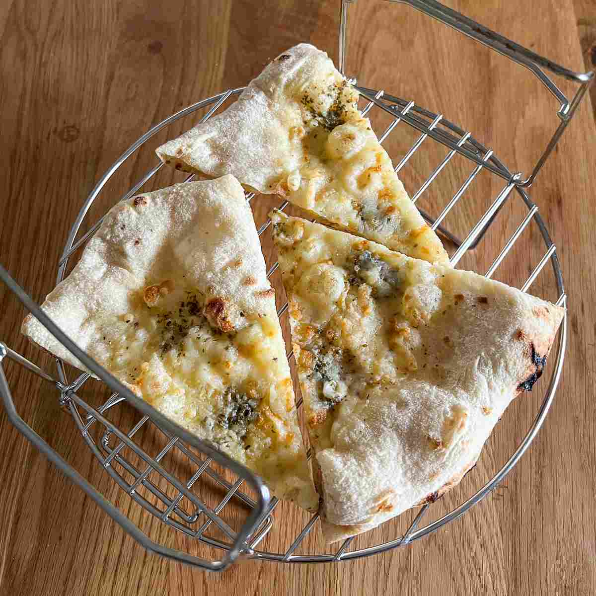 Image of Reheating leftover pizza on air fryer rack.