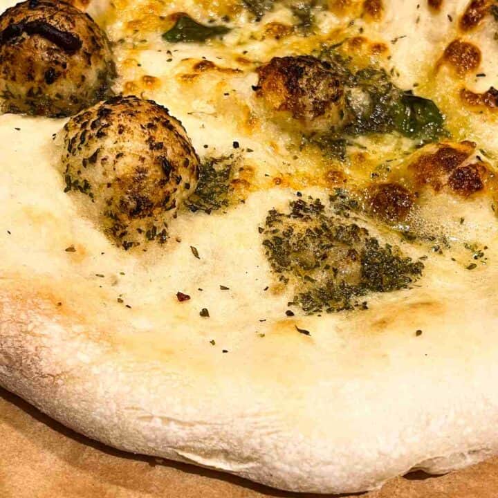 Garlic pizza bread on cutting board.