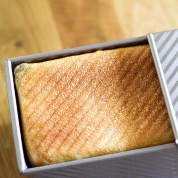 Bread being revealed from a pullman loaf tin.
