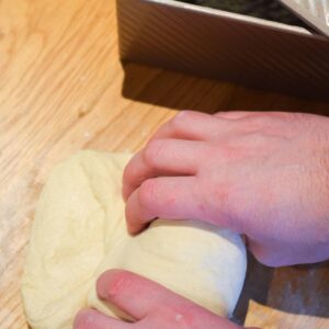 Shaping dough ready for adding to a pullman loaf tin.