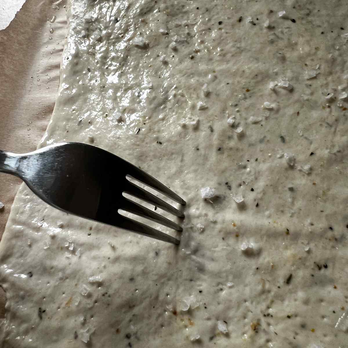 Pin prick sourdough discard lemon herb bites before cooking.