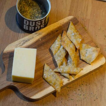 Sourdough bites on a charcuterie board with some cheese.