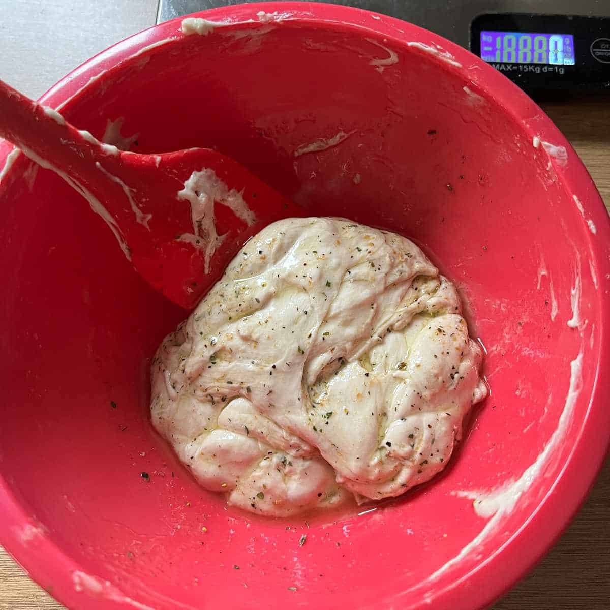 Mix the herbs and oil into the sourdough discard.