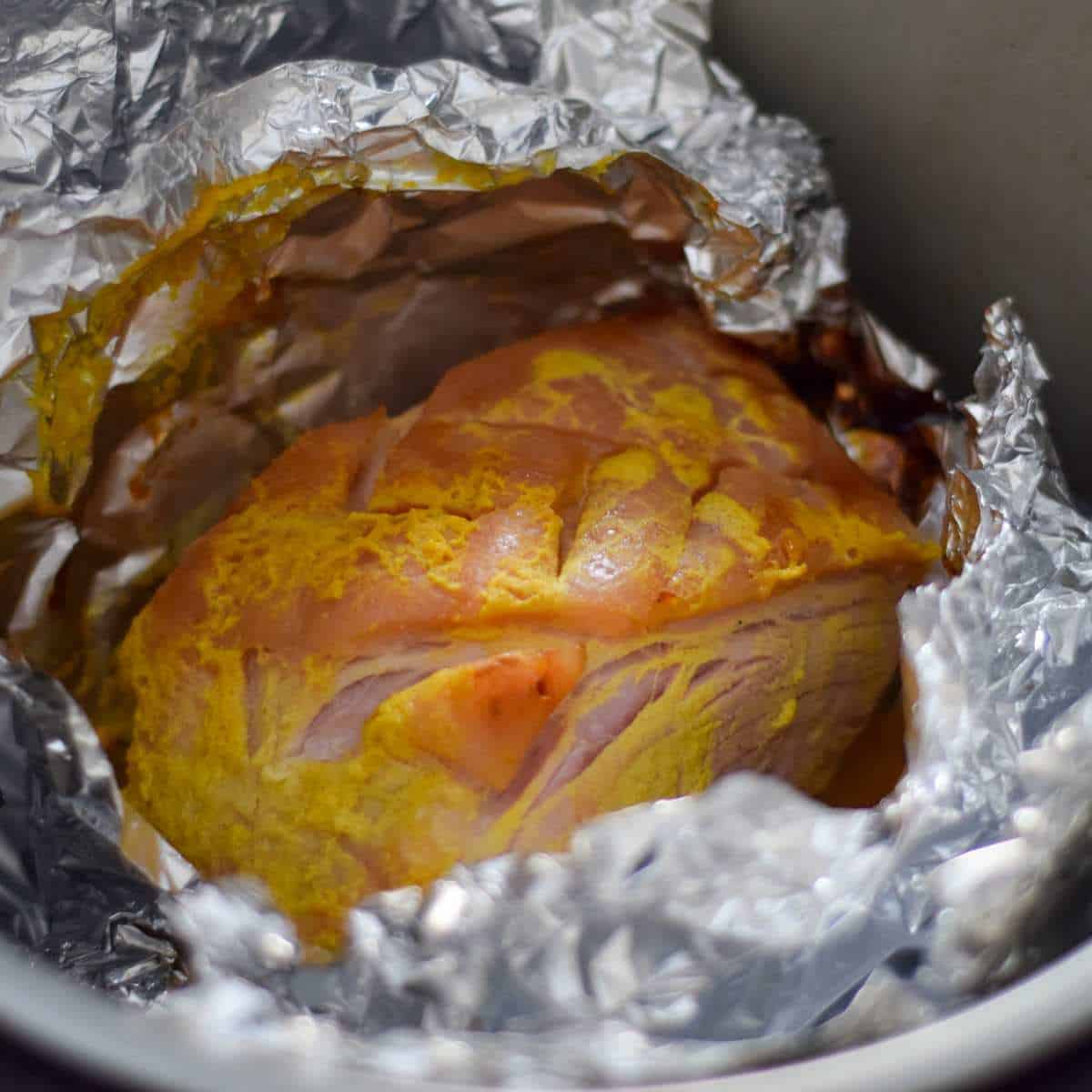 Unwrapping foil to show air fryer gammon.