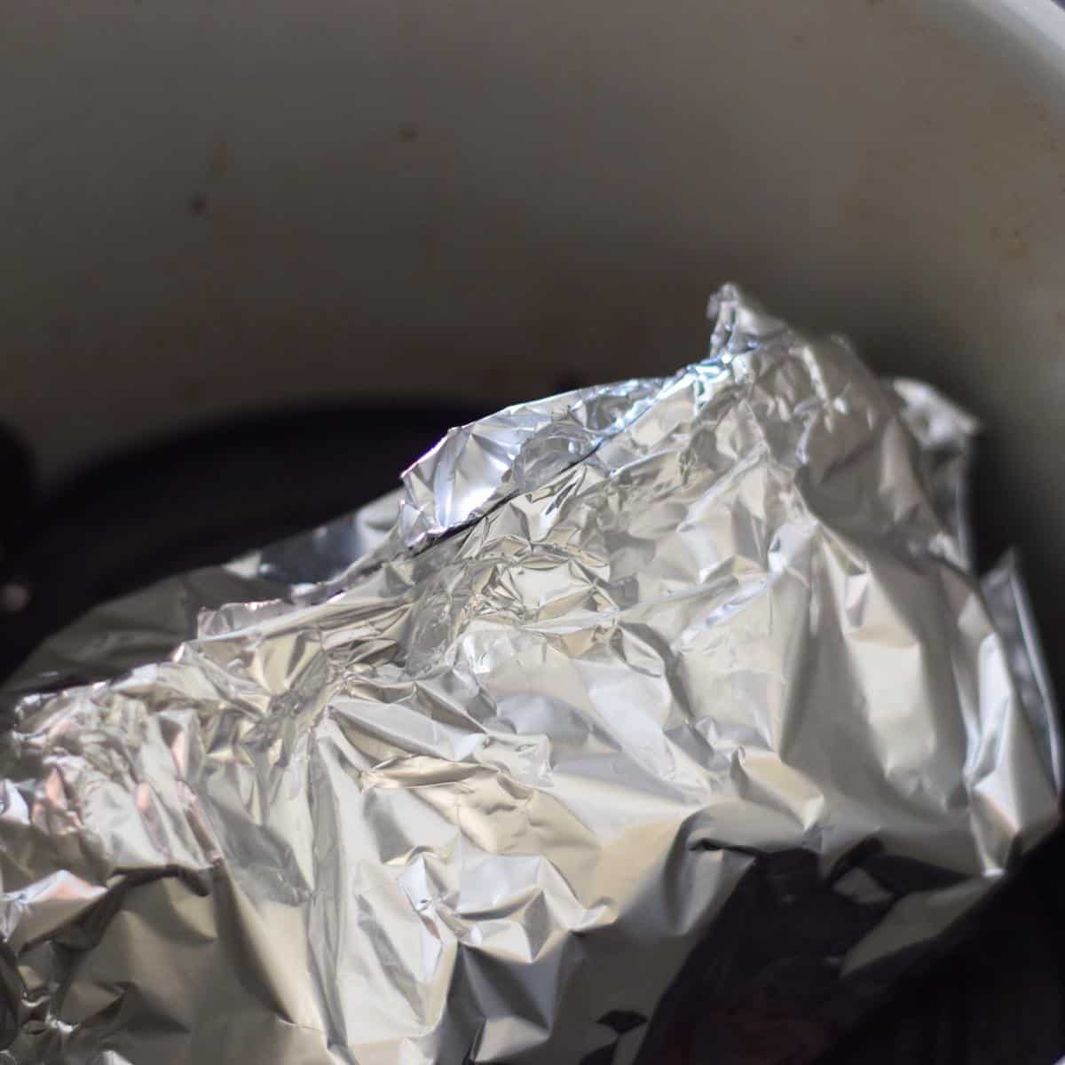 Wrapping honey and mustard gammon in foil.