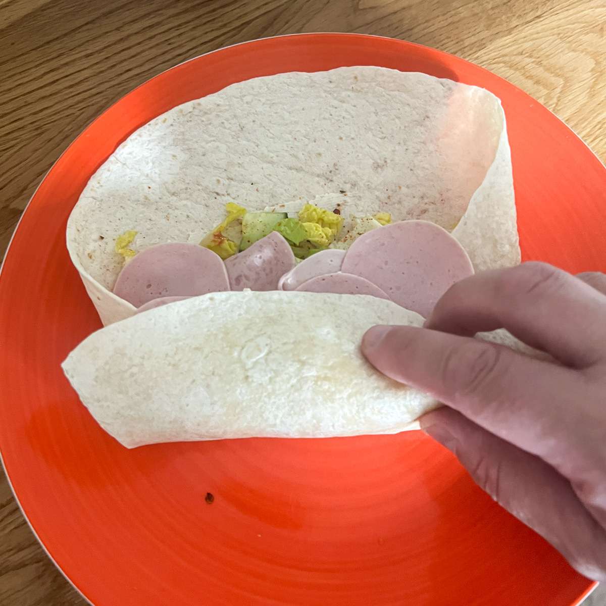 Tuck the wrap sides in and roll.