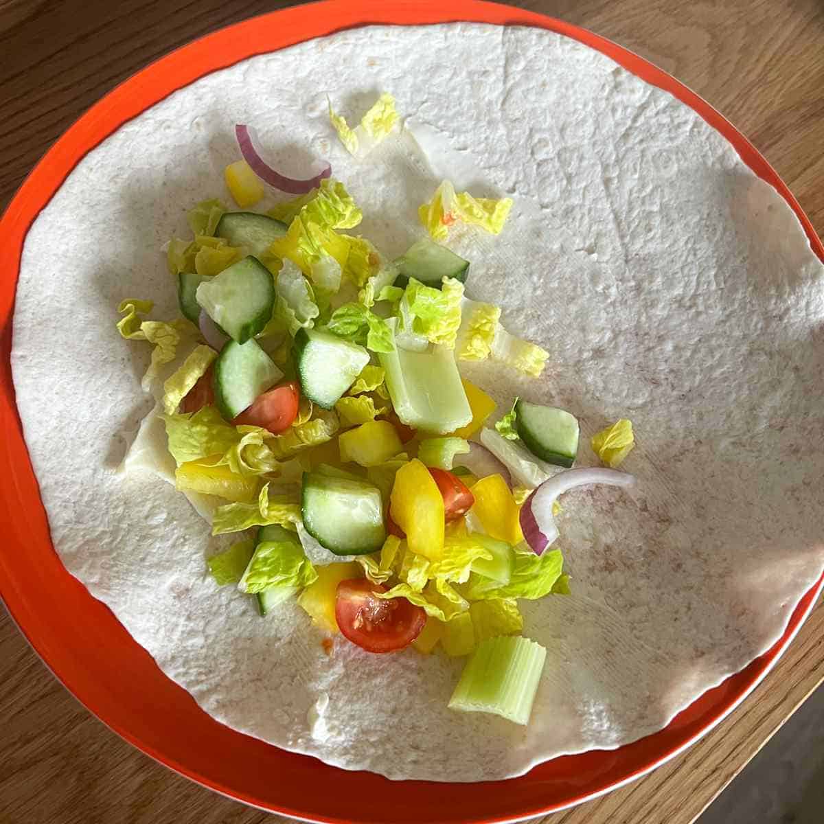 Place the salad on one third of the wrap