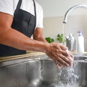 Image of man Washing hands in a sink