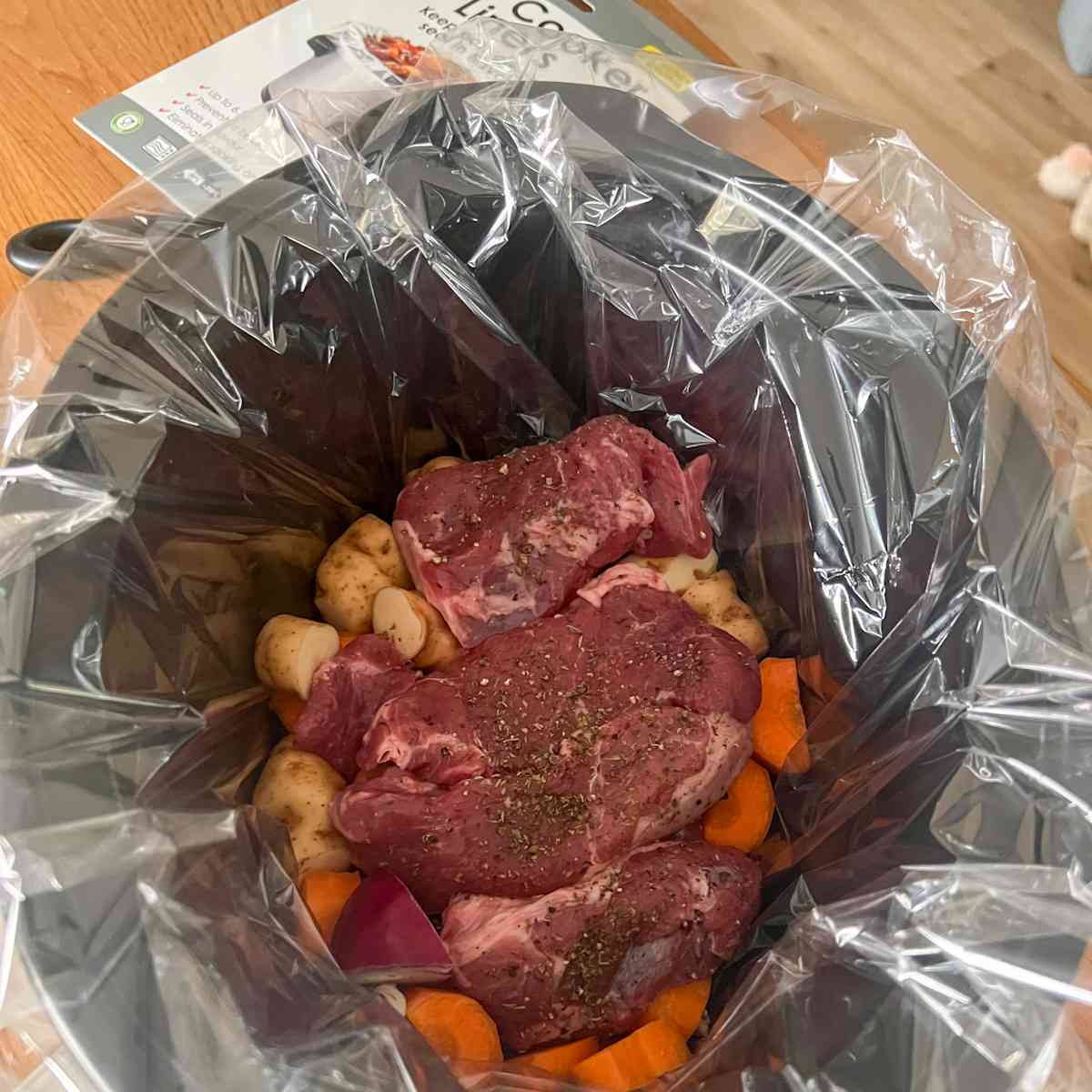 Lamb stew in slow cooker ingredients before cooking.