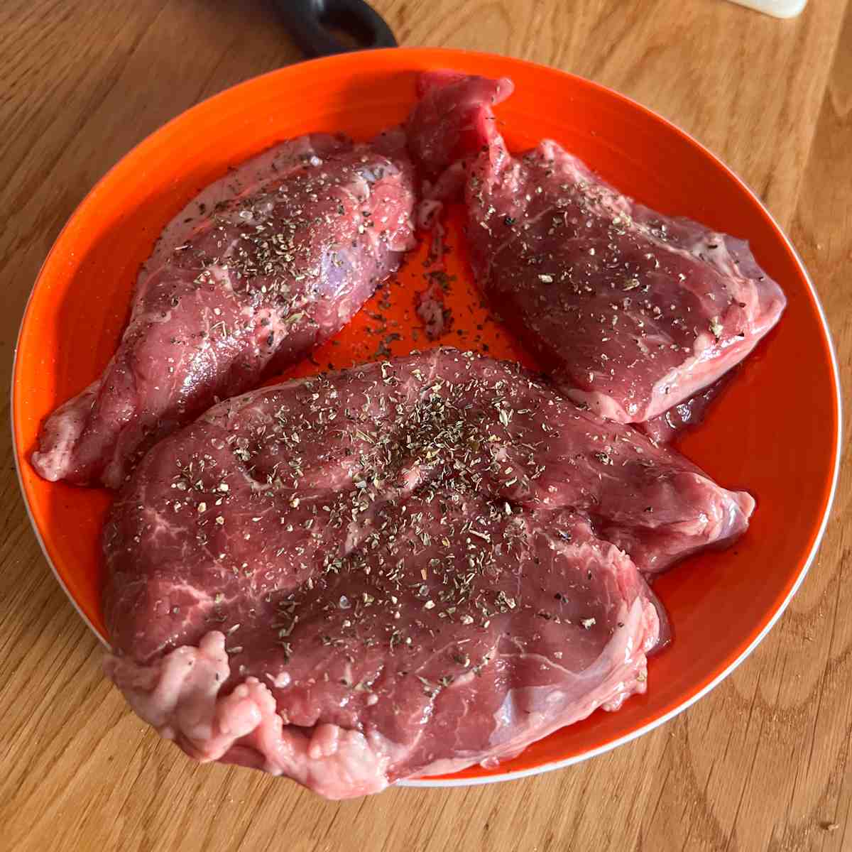 Lamb steaks covered in dried mint.