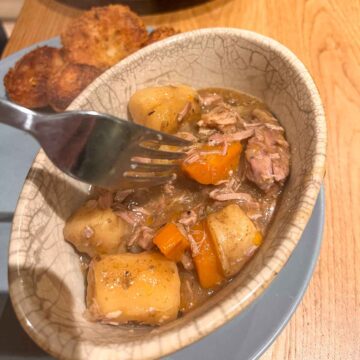 Image of Lamb stew in slow cooker on fork