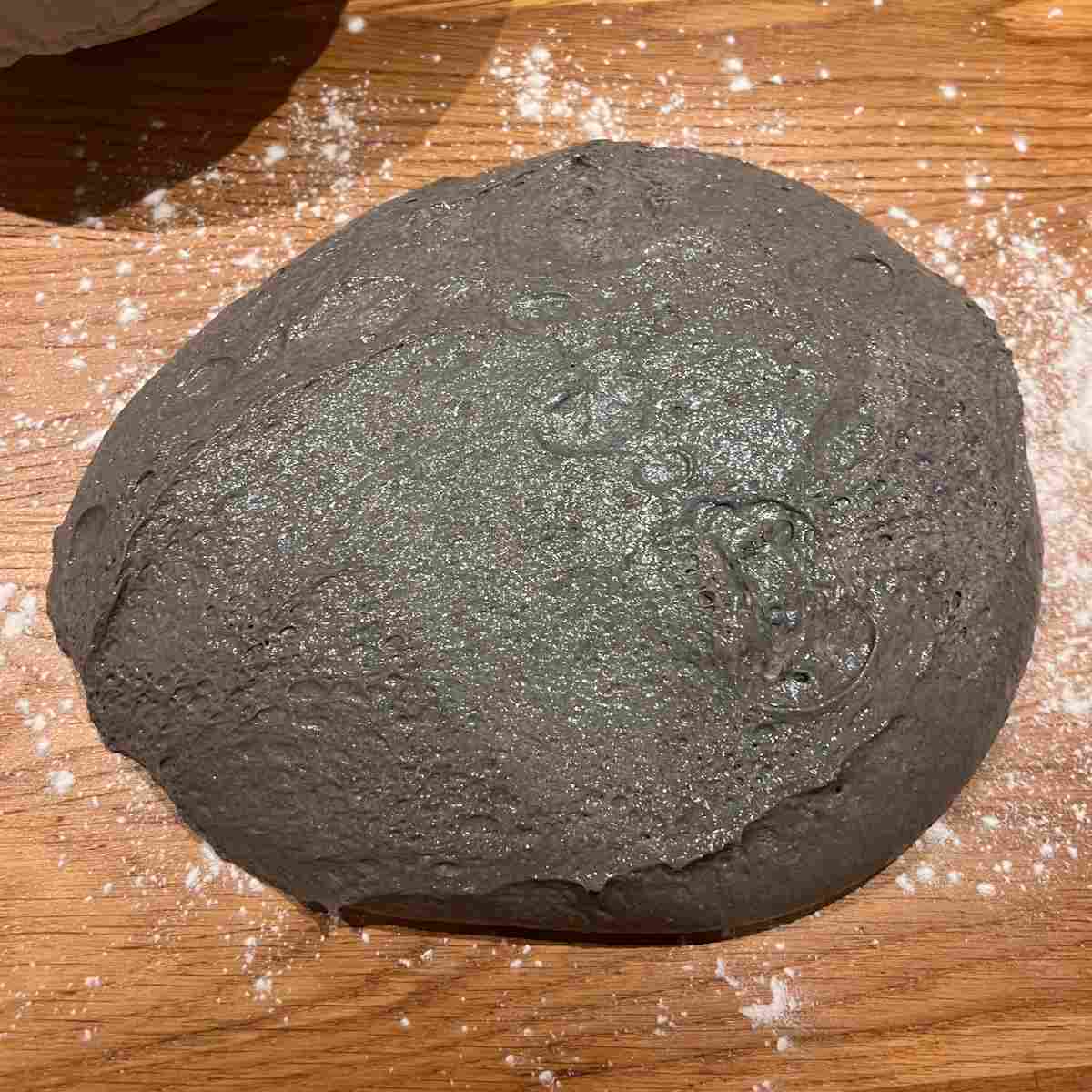 Shaping sourdough on a bench.