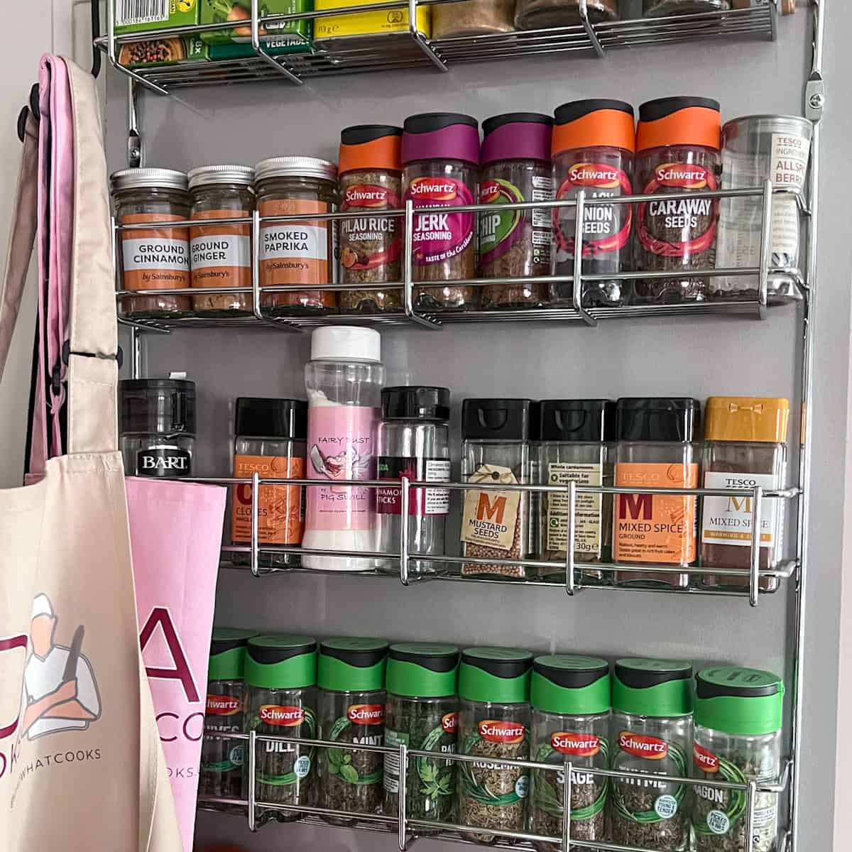 Cupboard door spice rack with various spices.