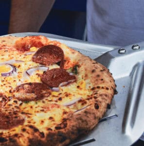 Pepperoni Pizza on a pizza peel.