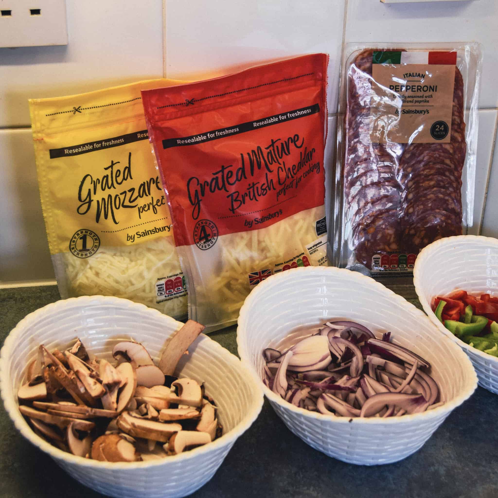 Various toppings for a pizza.